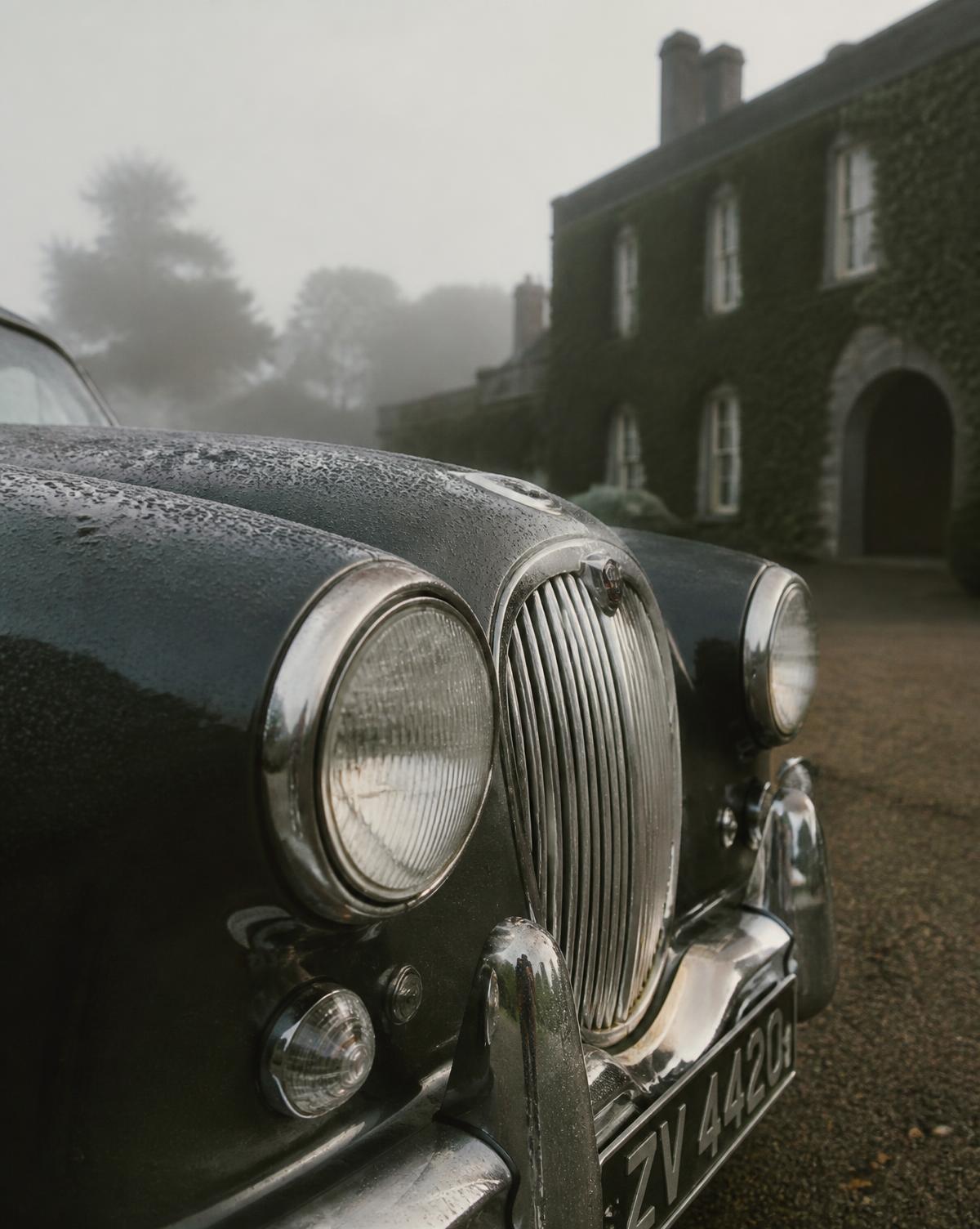 Chrome grille of a classic car in morning mist